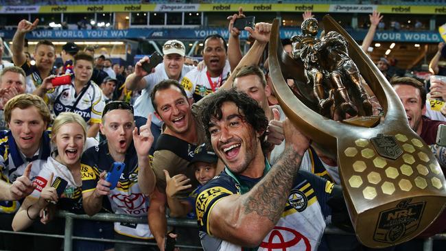 Cowboy's Johnathan Thurston holds the trophy in front of Cowboys fans after the 2015 NRL Grand Final. Pic Brett Costello