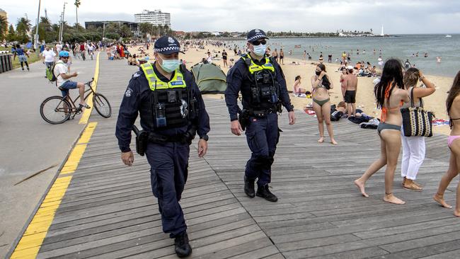 =Police patrol a crowded St Kilda beach. Picture: NCA NewsWire / David Geraghty