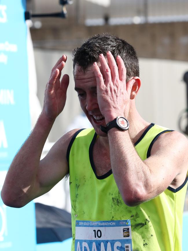 Australia's Liam Adams crosses the line in 6th at the Gold Coast Marathon. Photograph : Jason O'Brien