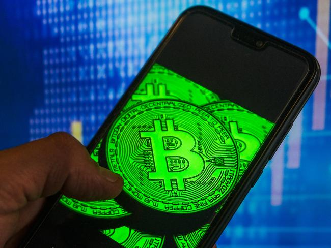 POLAND - 2021/05/18: In this photo illustration a Bitcoin logo seen displayed on a smartphone with stock market percentages in the background. (Photo Illustration by Omar Marques/SOPA Images/LightRocket via Getty Images)