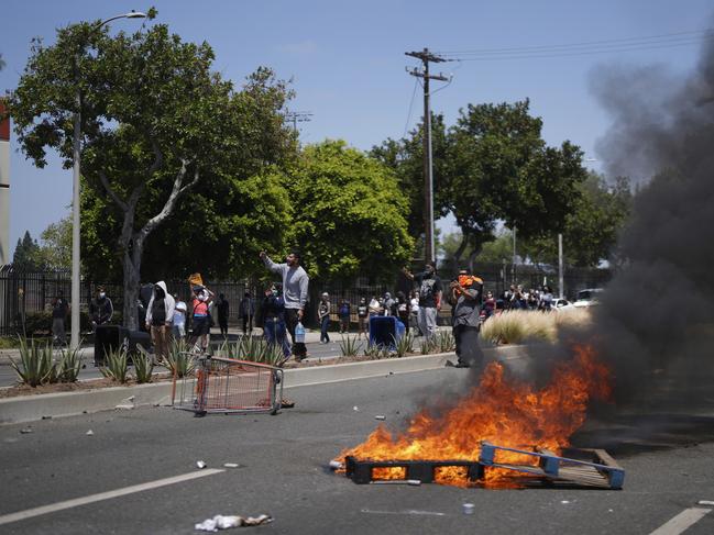 Demonstrators shout and film at police during a protest in the Paramount section of Los Angeles after federal immigration authorities conducted operations. Picture: AP