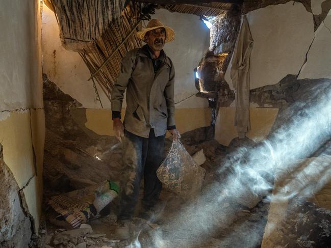 Ismail Aitbilla salvages items in the ruins of his home in Ardouz, Morocco. A huge earthquake measuring 6.8 on the Richter scale hit central Morocco on September 8, with almost 3000 people confirmed dead and many still missing as rescue operations struggle to reach the most affected areas. Whilst the epicentre was in a sparsely populated area of the High Atlas Mountains, its effects have been felt 71km away in Marrakesh. Picture: Carl Court/Getty Images 