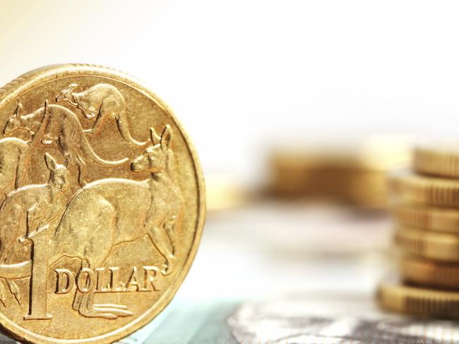 Generic photo of an Australian dollar coin .. Aussie one dollar coins, on a twenty dollar note.