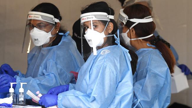 Health workers at a drive-through Covid-19 testing clinic at Murarrie in Brisbane. Picture: Dan Peled