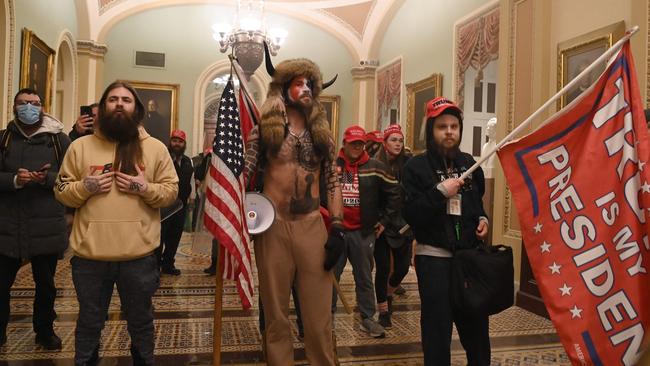 Trump supporters, including member of the QAnon conspiracy group Jake Angeli, aka Yellowstone Wolf (C), enter the US Capitol on January 6 2021. Picture: AFP.