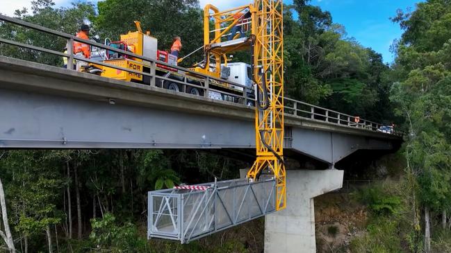 Roadtek employees work on the underside of the Barron River bridge at Kuranda. Picture: TMR