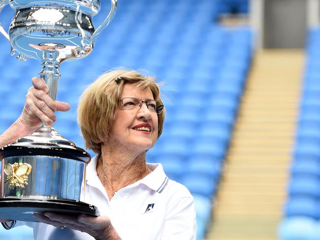 Margaret Court with the Australian Open trophy on the court named after her. Picture: Jason Sammon