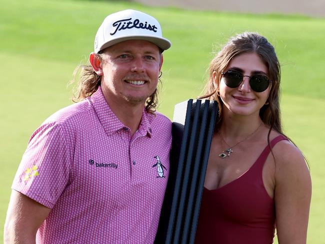 ST ALBANS, ENGLAND - JULY 09: Cameron Smith of Australia poses with his girlfriend Shanel Naoum after his win on day three of LIV Golf - London at The Centurion Club on July 09, 2023 in St Albans, England. (Photo by Tom Dulat/Getty Images)