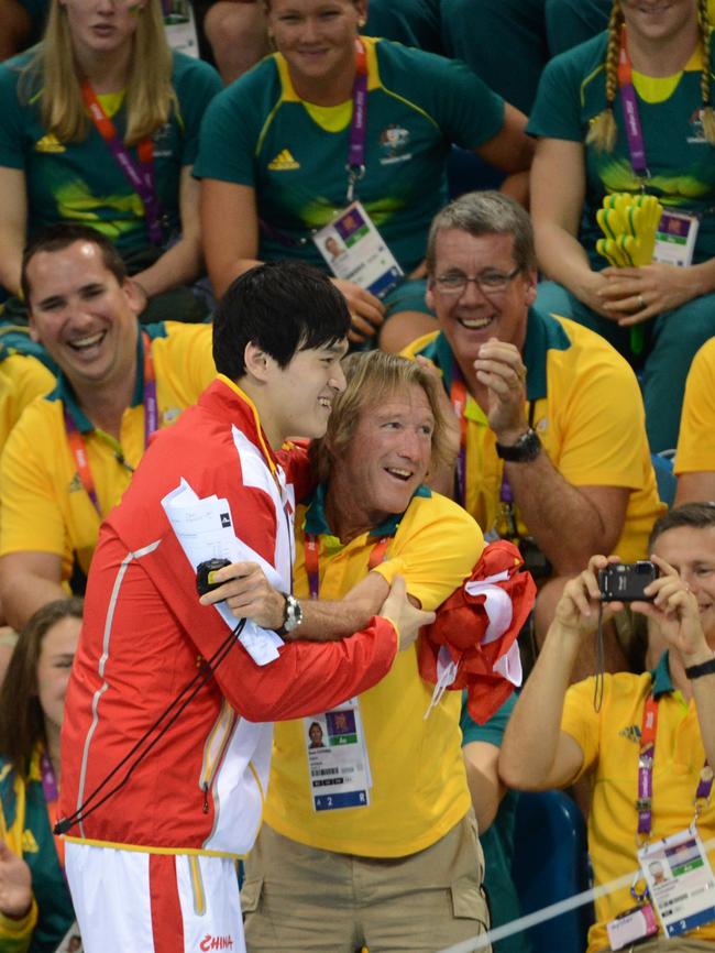 Yang hugs Australian coach Denis Cotterell after winning the men's 1500m freestyle final during the swimming event at the London 2012 Olympic Picture: Christophe Simon