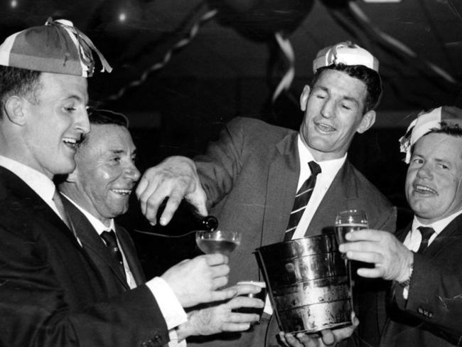 John Raper (L) and Norm Provan (2nd R) celebrate their 1961 Grand Final win with coach Ken Kearney. Picture: Winton Irving