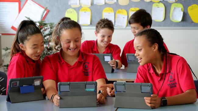 Camberwell Primary School Year 6 students Rhea, Grace, Kayleigh, James and Brando using iPads. Picture: Stuart McEvoy. 