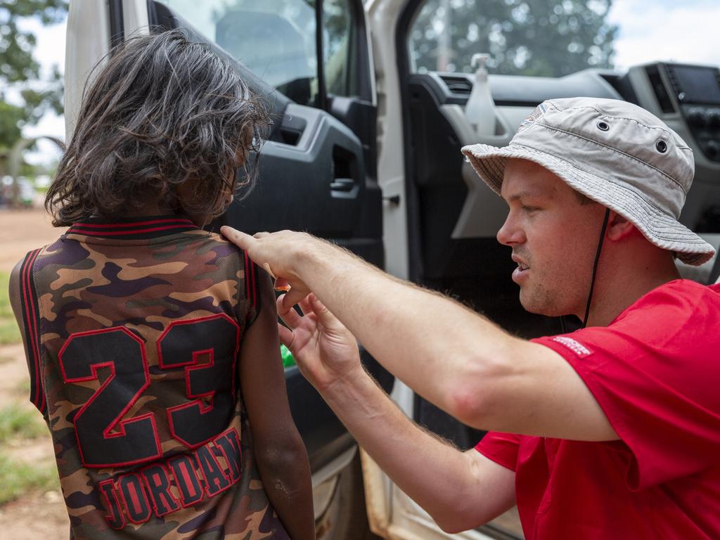 NT Health nurse Aydan Boscheinen gives a Wurrumiyanga kid his second Covid-19 jab. Picture: Floss Adams.