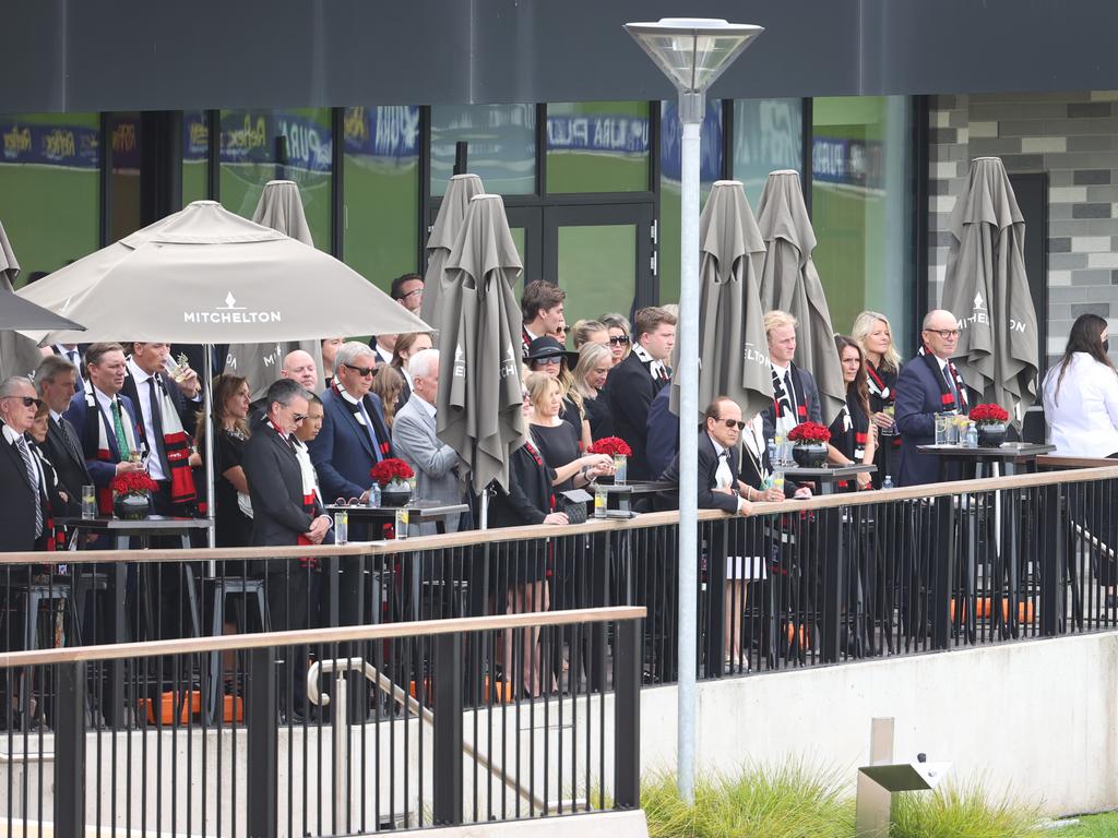 Guests watch from the clubhouse as the hearse carrying Shane Warne’s coffin does a lap of the ground. Picture: David Caird