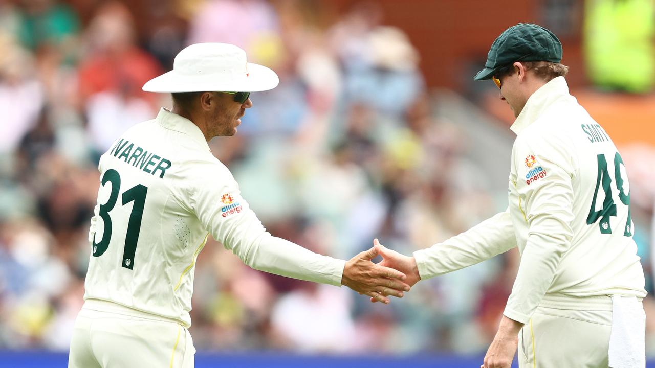 David Warner and Steve Smith shake hands during the second Test in Adelaide. Picture: Chris Hyde/Getty