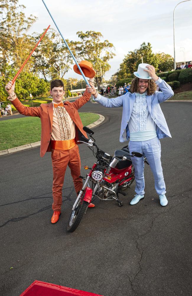 Graduate Daniel Sheath (right) and partner Matthew Thom arrive as Dumb and Dumber characters on a postie bike at Mary MacKillop Catholic College formal at Highfields Cultural Centre, Thursday, November 14, 2024. Picture: Kevin Farmer