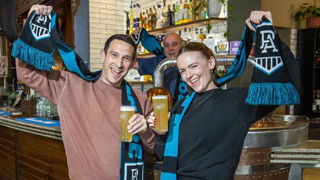 Port fans Joseph Vella, Karl Cornel and Adele Spark get ready to cheer on the Power at the Archer Hotel in North Adelaide. Picture: Mark Brake