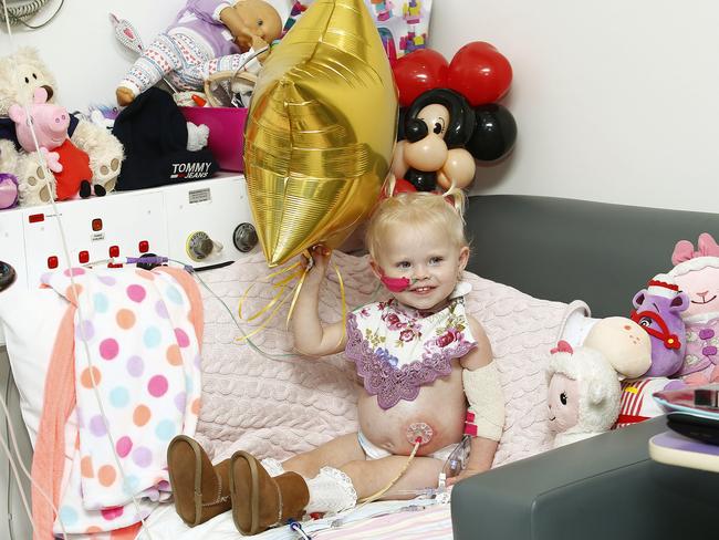 Elliana Smith, 2, with a gold star balloon and wearing her EMU Boots she received to celebrate Gold day. Picture: John Appleyard