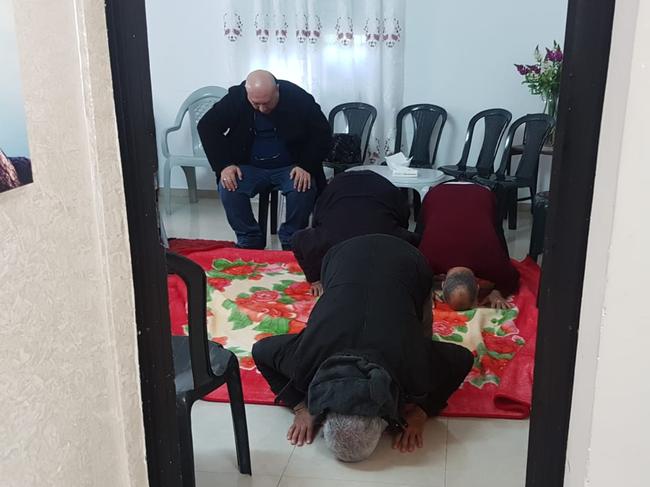 Men praying at Aiia Maasarwe’s family home. Picture: Shakked Auerbach