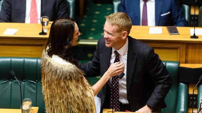 Jacinda Ardern hugs Prime Minister Chris Hipkins after her valedictory speech. Picture: AFP.