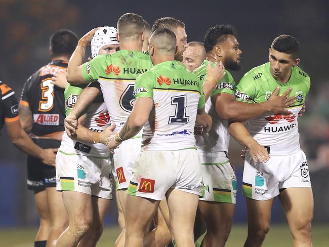 SYDNEY, AUSTRALIA - JUNE 13: The Raiders celebrate a turnover during the round five NRL match between the Wests Tigers and the Canberra Raiders at Campbelltown Stadium on June 13, 2020 in Sydney, Australia. (Photo by Mark Kolbe/Getty Images)