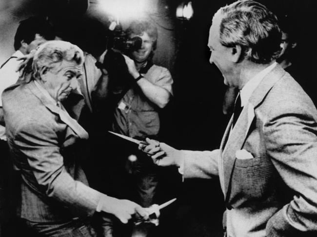 NOVEMBER, 1988 : Prime Minister Bob Hawke (L) and the Opposition's Andrew Peacock duel with sissors at the opening of the radio alley in the new press gallery at Parliament House, Canberra, 11/88. Pic News Ltd.Historical