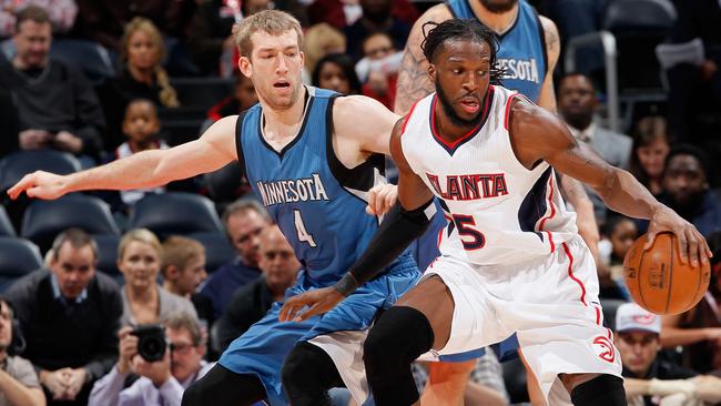 DeMarre Carroll of the Atlanta Hawks spins against Robbie Hummel of the Minnesota Timberwolves.