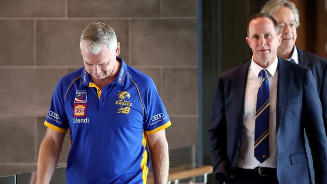 PERTH, AUSTRALIA - JULY 09: Adam Simpson walks to a press conference with Don Pyke (WCE CEO) and Paul Fitzpatrick (WCE Chair) after the West Coast Eagles and senior coach Adam Simpson mutually agreed that his 11-year tenure at the club will come to an end during a West Coast Eagles AFL press conference at Mineral Resources Park on July 09, 2024 in Perth, Australia. (Photo by Paul Kane/Getty Images)