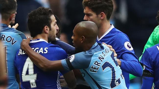 Cesc Fabregas of Chelsea and Fernandinho of Manchester City clash.