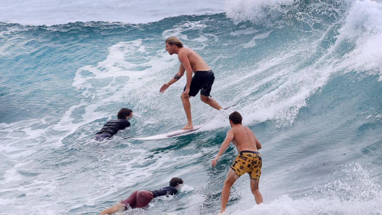 Drop ins were aplenty Surfers as large numbers of surfers line up for a wave at Burleigh Heads as wet weather descended over the Gold Coast. Photo: Scott Powick NEWSCORP