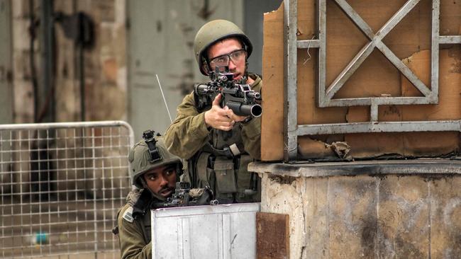 Israeli soldiers take aim in the centre of Hebron on Tuesday. Picture: AFP