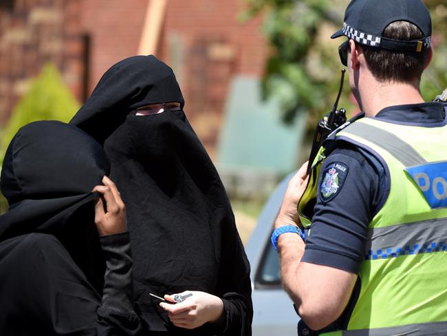 Police speak with two women at the scene of a raid in Meadow Heights. Picture: Nicole Garmston