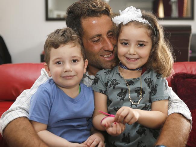 Noah and Lahela al-Amin pose for a picture with their father Ali Zeid al-Amin at home in Beirut. Picture: The Daily Star/Mohammad Azakir.