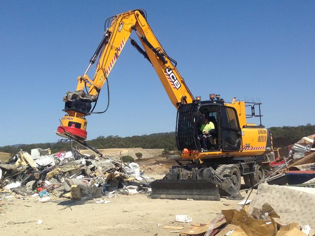 Central Coast Council's excavator sorting through household kerbside collection waste at Buttonderry Waste Management Facility