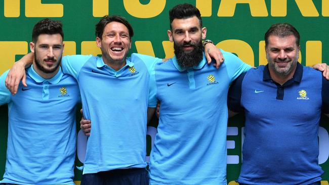 Ange Postecoglou and Mile Jedinak celebrate qualifying for the World Cup. Picture: AFP Photo