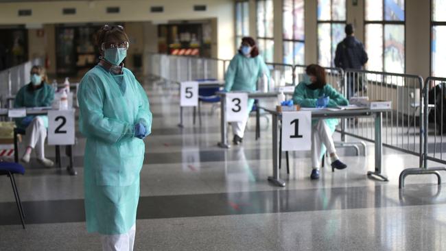 Nurses wait for patients at the main entrance of the Brescia hospital, northern Italy. Picture: AP.