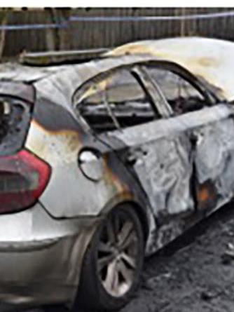 Burnt-out car found after the shooting.