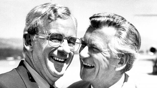 Bill Hayden shares laugh with Bob Hawke at Fairbairn RAAF Base, Canberra.