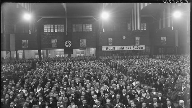 A part meeting with a sign reading "Kauft nicht bei Juden"- Don't buy from Jews.