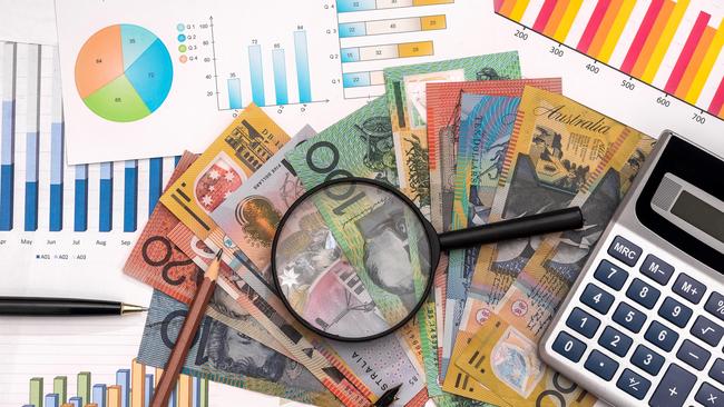 Business graphs with australian dollars, magnifier, pen and calculator Australian money tax generic