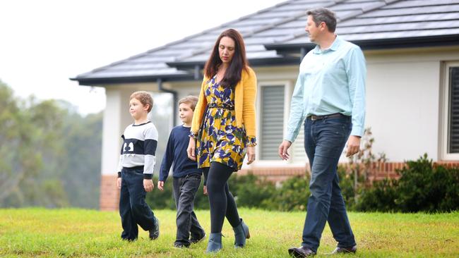 Rebecca Baldwin and Matthew Marshall with Myles, 5, and Max, 6, on their property in Maraylya. The fear it is in the path of the M9. Picture: AAP Image/Angelo Velardo