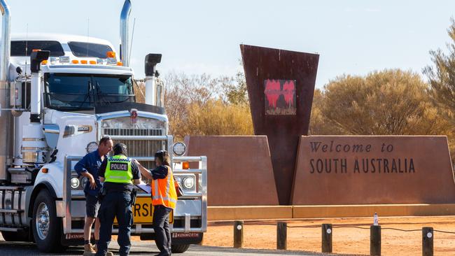 A road train and its safety vehicle were the first to be stopped by NT Police at the NT/SA border after coronavirus border restrictions came into effect at 4pm on Tuesday, March 24. Photo: Emma Murray