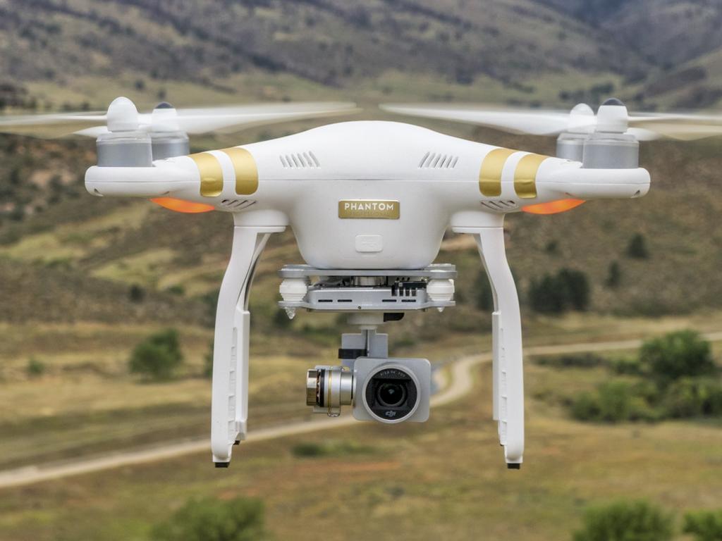 Fort Collins, CO, USA  - September 11, 2015:  Radio controlled Phantom 3 quadcopter drone is flying with a camera over foothills of Rocky Mountains.