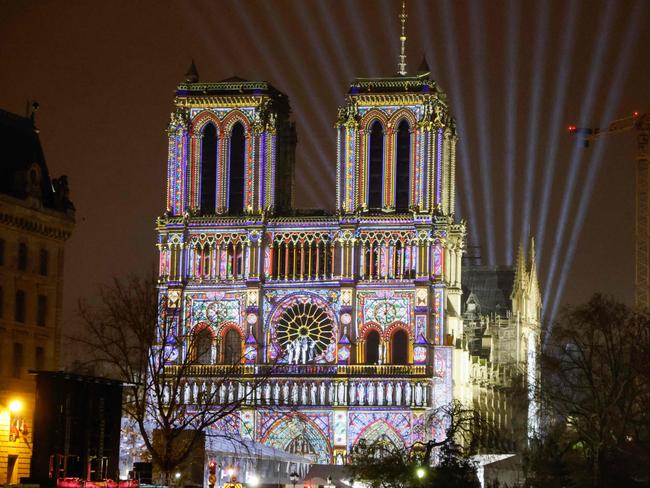 This photograph taken on December 5, 2024 shows the Notre-Dame de Paris cathedral illuminated along the Seine river, in Paris, a few days before its reopening on December 7, 2024. (Photo by Ludovic MARIN / AFP)