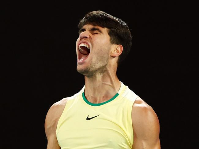 MELBOURNE, AUSTRALIA - JANUARY 22: Carlos Alcaraz of Spain celebrates a point during their fourth round singles match against Miomir Kecmanovic of Serbia during the 2024 Australian Open at Melbourne Park on January 22, 2024 in Melbourne, Australia. (Photo by Graham Denholm/Getty Images)