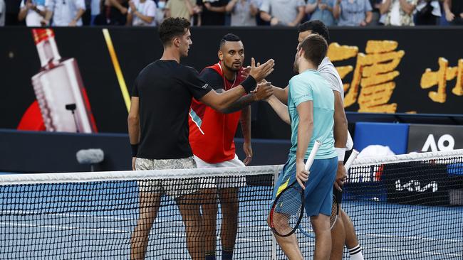 Kyrgios and Kokkinakis shake hands with Nikola Mektic and Mate Pavic after winning their second round doubles match. Picture: Darrian Traynor/Getty Images