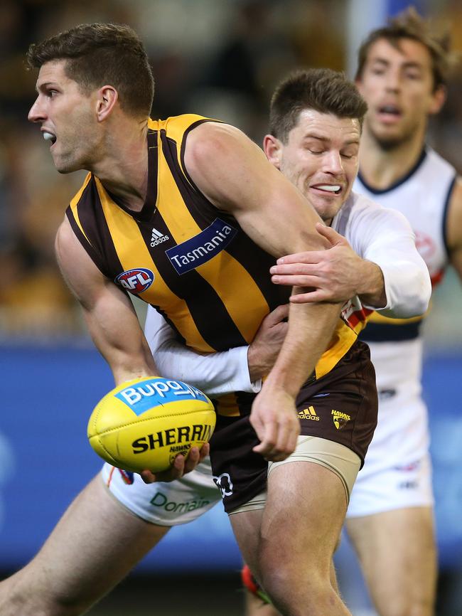 Bryce Gibbs wraps up Hawthorn’s Luke Breust. Picture: Michael Klein