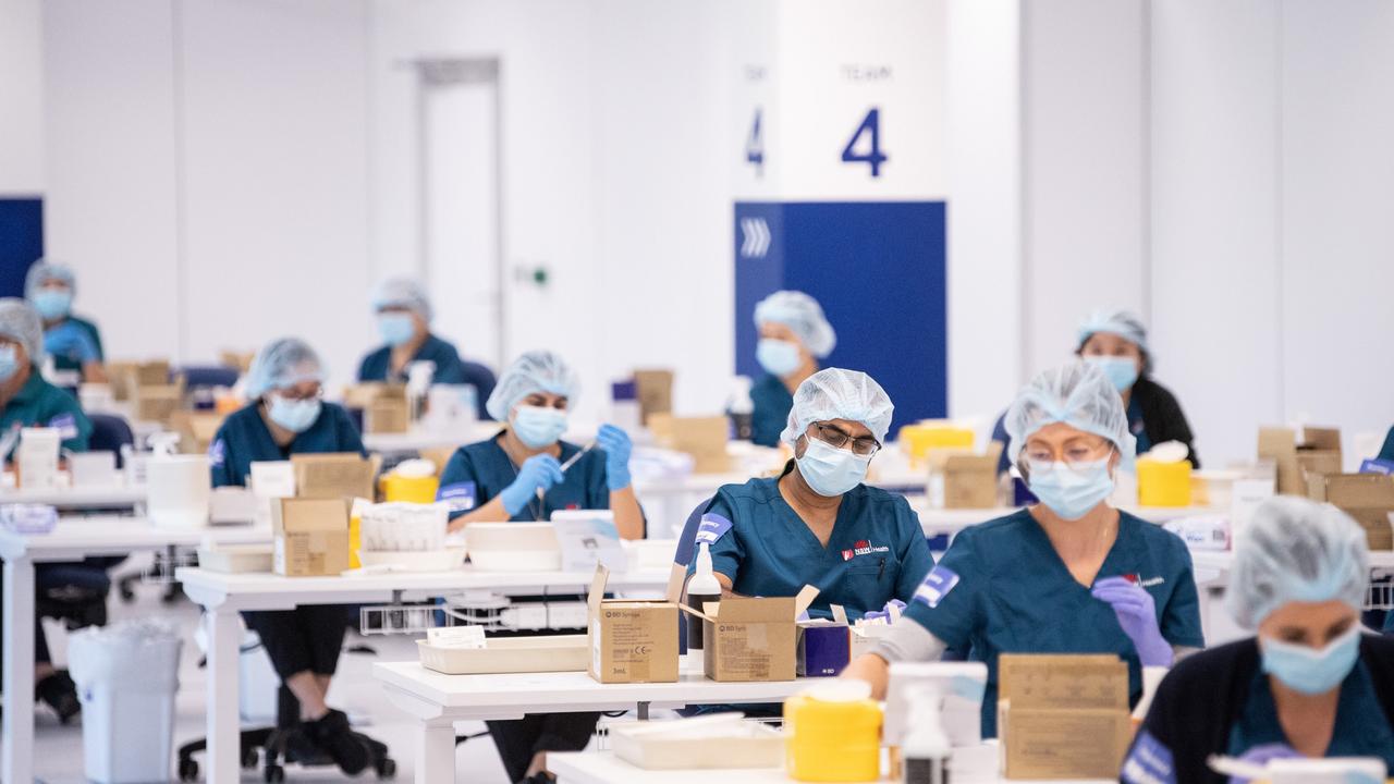 Staff prepare Covid vaccines at Sydney’s Olympic Park Vaccination Centre in May last year. Picture: Getty