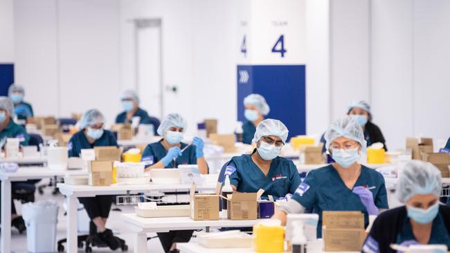 Staff prepare Covid vaccines at Sydney’s Olympic Park Vaccination Centre in May last year. Picture: Getty