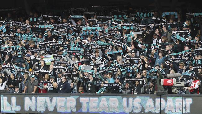 Port Adelaide fans share a moment pre-game before a Showdown.