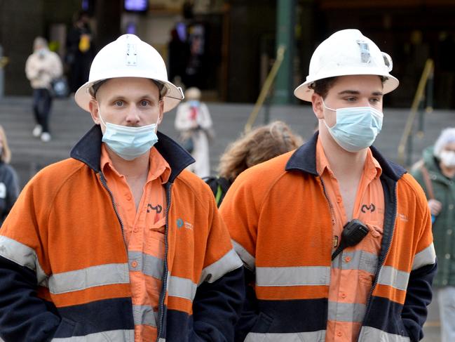 MELBOURNE, AUSTRALIA - NewsWire Photos JULY 28, 2021: Construction workers outside Flinders Street Station after Melbourne's latest lockdown ended overnight. Picture: NCA NewsWire / Andrew Henshaw